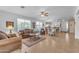 Open living room with tiled floors, a ceiling fan and views to the kitchen at 22992 W Lasso Ln, Buckeye, AZ 85326