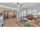 Living room features tiled floors, a ceiling fan, and built-in cabinetry at 22992 W Lasso Ln, Buckeye, AZ 85326