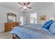 Main bedroom with a large bed and ensuite bathroom access at 22992 W Lasso Ln, Buckeye, AZ 85326