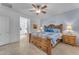 Main bedroom with wood furniture and ceiling fan at 22992 W Lasso Ln, Buckeye, AZ 85326