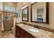 Double vanity bathroom with granite countertops and a walk-in shower at 2310 W Hazelhurst Dr, Anthem, AZ 85086