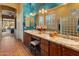 Elegant bathroom with double vanity, granite countertops, and a glass block shower at 2310 W Hazelhurst Dr, Anthem, AZ 85086