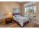 Cozy bedroom with wood furniture, plantation shutters, and a neutral color scheme at 2310 W Hazelhurst Dr, Anthem, AZ 85086