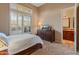 Serene bedroom with large windows, plantation shutters, and access to a full bathroom at 2310 W Hazelhurst Dr, Anthem, AZ 85086