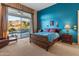 Bright bedroom with mountain views and a pool view, featuring a sleigh bed and blue walls at 2310 W Hazelhurst Dr, Anthem, AZ 85086