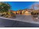 Beautiful home exterior with a two-car garage and lighting at 2310 W Hazelhurst Dr, Anthem, AZ 85086