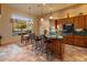 Eat-in kitchen with island seating, granite countertops, and views to backyard at 2310 W Hazelhurst Dr, Anthem, AZ 85086