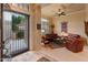 Spacious living room with leather sofas and a large window at 2310 W Hazelhurst Dr, Anthem, AZ 85086