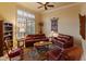 Relaxing living room with leather sofas and a ceiling fan at 2310 W Hazelhurst Dr, Anthem, AZ 85086