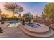 Beautiful kidney shaped pool and spa with a tranquil fountain and desert landscaping at 2310 W Hazelhurst Dr, Anthem, AZ 85086