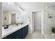 Elegant bathroom with double vanity, blue cabinets, and a walk-in shower at 2425 W Bronco Butte Trl # 1032, Phoenix, AZ 85085