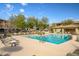 Community pool with lounge chairs and a waterfall feature at 2425 W Bronco Butte Trl # 1032, Phoenix, AZ 85085