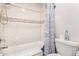 Bathroom with white subway tile and shower/tub combo at 2535 W Canyon Crest Cir, Phoenix, AZ 85023