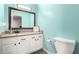 A light teal accent wall and granite vanity add charm to this bathroom at 2535 W Canyon Crest Cir, Phoenix, AZ 85023