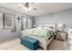 Main bedroom with ceiling fan, large windows, and a teal bench at 2535 W Canyon Crest Cir, Phoenix, AZ 85023