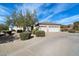 House exterior featuring a three-car garage and drought-tolerant landscaping at 26846 N 73Rd St, Scottsdale, AZ 85266