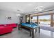 Pool table and sitting area with sliding glass doors opening to a patio and pool at 26846 N 73Rd St, Scottsdale, AZ 85266