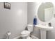 Clean bathroom with pedestal sink, toilet, and oval mirror at 2715 S Sailors Way, Gilbert, AZ 85295