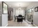 Bright dining room with gray walls, wood-look floors, and sliding glass door at 2715 S Sailors Way, Gilbert, AZ 85295