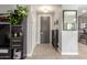 Bright entryway with dark gray door, wood-look tile floor, and built-in shelving at 2715 S Sailors Way, Gilbert, AZ 85295