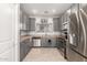 Modern kitchen with gray cabinets, granite counters, and stainless steel appliances at 2715 S Sailors Way, Gilbert, AZ 85295