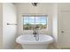 Luxurious bathroom with freestanding tub and mountain views at 27921 N 153Rd St, Scottsdale, AZ 85262