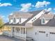 White two-story home with gray roof and wrap-around porch at 27921 N 153Rd St, Scottsdale, AZ 85262