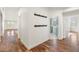 Inviting entryway with wood floors and coat rack, leading to kitchen at 27921 N 153Rd St, Scottsdale, AZ 85262