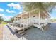 White house exterior with a large wrap around porch and landscaped yard at 27921 N 153Rd St, Scottsdale, AZ 85262