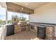 Outdoor kitchen with stone countertops and high-end appliances at 27921 N 153Rd St, Scottsdale, AZ 85262