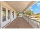 Spacious covered porch with wooden flooring and white railings at 27921 N 153Rd St, Scottsdale, AZ 85262