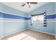 Spacious bedroom with blue and white striped wall accents at 3210 E Brookwood Ct, Phoenix, AZ 85048