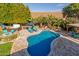 Inviting freeform pool with flagstone patio and built-in spa at 3210 E Brookwood Ct, Phoenix, AZ 85048