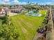 Aerial view of a house with a large backyard, pool, and sports court at 356 W Ivanhoe St, Gilbert, AZ 85233