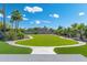 Landscaped backyard with lush green grass and a winding pathway at 356 W Ivanhoe St, Gilbert, AZ 85233