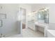 Modern bathroom with a glass shower, vanity, and bathtub at 356 W Ivanhoe St, Gilbert, AZ 85233