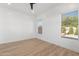 Modern bedroom with wood-look flooring and two windows at 356 W Ivanhoe St, Gilbert, AZ 85233