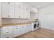 Laundry room with white cabinets and wood countertop at 356 W Ivanhoe St, Gilbert, AZ 85233