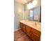 Clean bathroom with wood cabinets and updated fixtures at 35706 W Costa Blanca Dr, Maricopa, AZ 85138