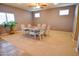 Bright dining room with a square wooden table and six chairs at 35706 W Costa Blanca Dr, Maricopa, AZ 85138