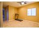 Room with a treadmill and tile floors; could be used as an office or bedroom at 35706 W Costa Blanca Dr, Maricopa, AZ 85138