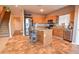 Kitchen with an island, stainless steel appliances, and wood cabinets at 35706 W Costa Blanca Dr, Maricopa, AZ 85138