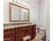 Bathroom with granite countertop, wooden cabinets, and a step stool at 36627 N 18Th Dr, Phoenix, AZ 85086