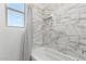 Clean bathroom with marble tile shower/tub surround at 36627 N 18Th Dr, Phoenix, AZ 85086