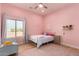 Charming pink bedroom with large window and plenty of light at 36627 N 18Th Dr, Phoenix, AZ 85086