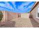 Low maintenance backyard features a gravel area with a storage shed and block fence at 3711 E Sandy Way, Gilbert, AZ 85297