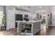 Kitchen island with granite counters, stainless steel appliances and adjacent dining area at 3711 E Sandy Way, Gilbert, AZ 85297