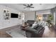 This living room features stylish decor, a ceiling fan, and a sliding glass door to the backyard at 3711 E Sandy Way, Gilbert, AZ 85297