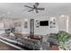 Bright living room with built-in shelving, a ceiling fan, and views into the kitchen at 3711 E Sandy Way, Gilbert, AZ 85297