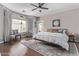 Stylish main bedroom featuring hardwood floors, an area rug, and a ceiling fan at 3711 E Sandy Way, Gilbert, AZ 85297